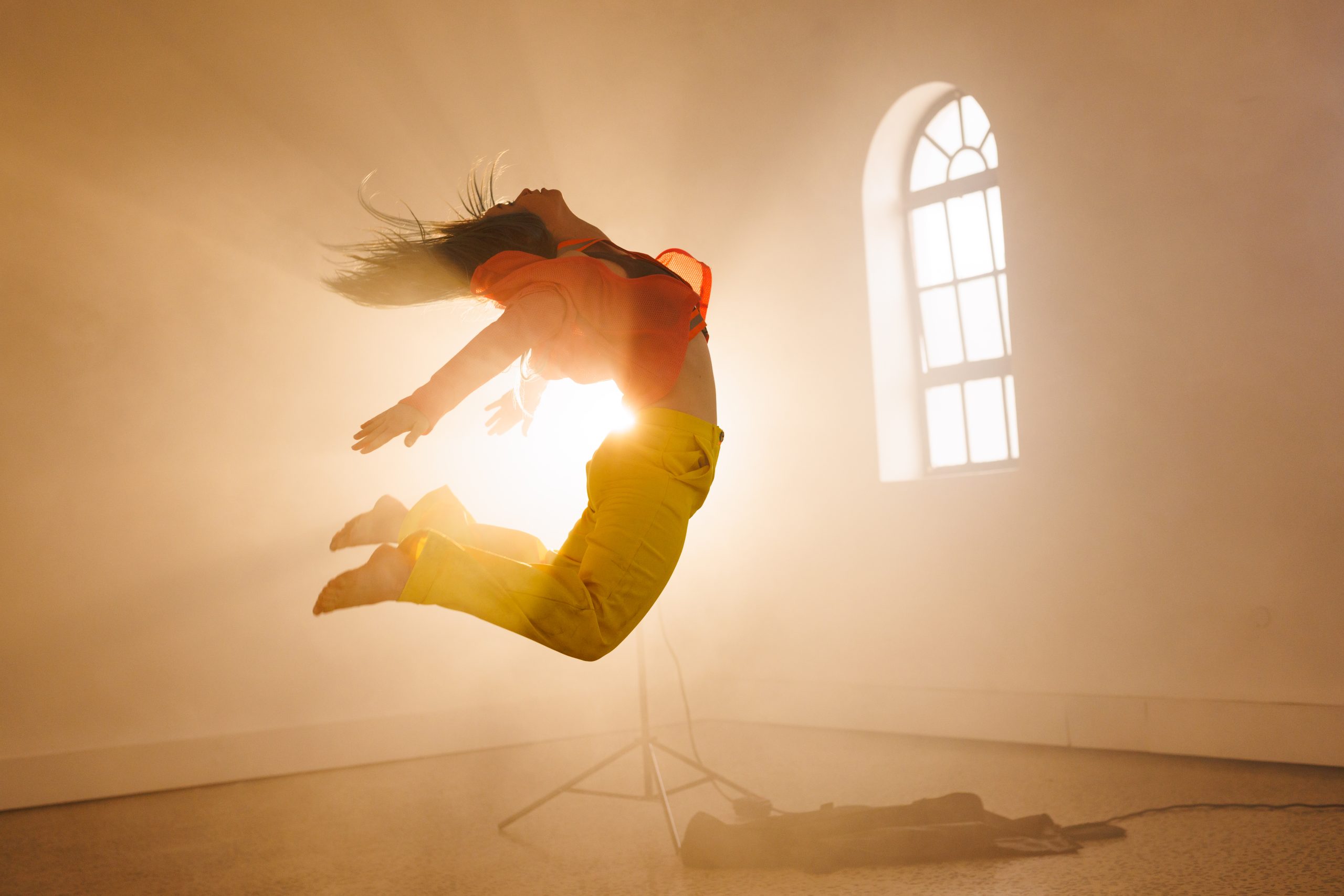 A figure leaping in sunlight — the release when something long stuck begins to move