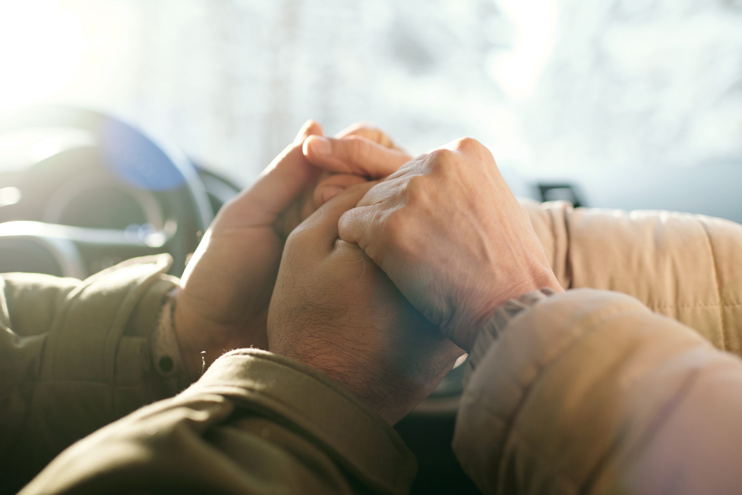 hands holding one another as if supporting one another