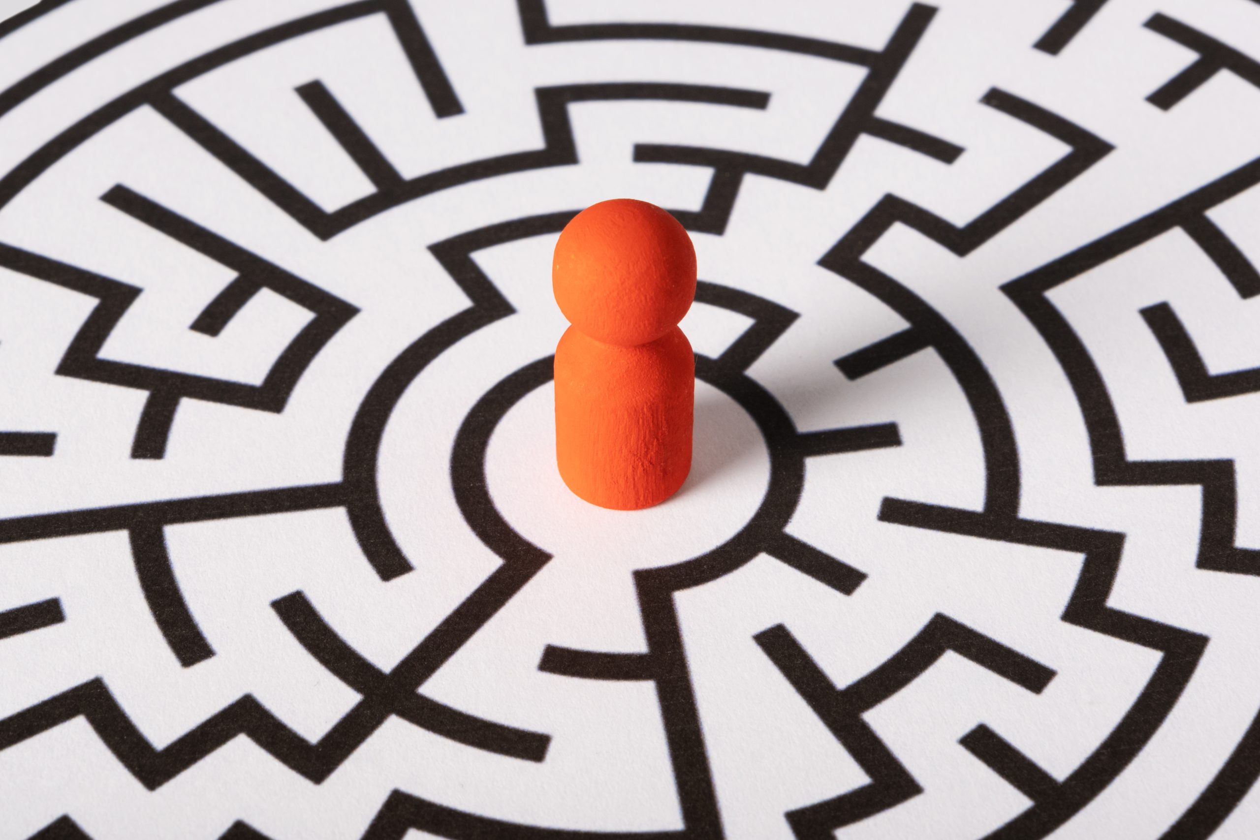 an ornage figure standing in the centre of a maze